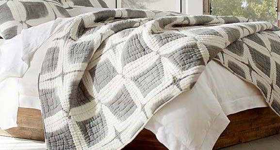 Quilt cover with squarish blocks with filled center and white borders